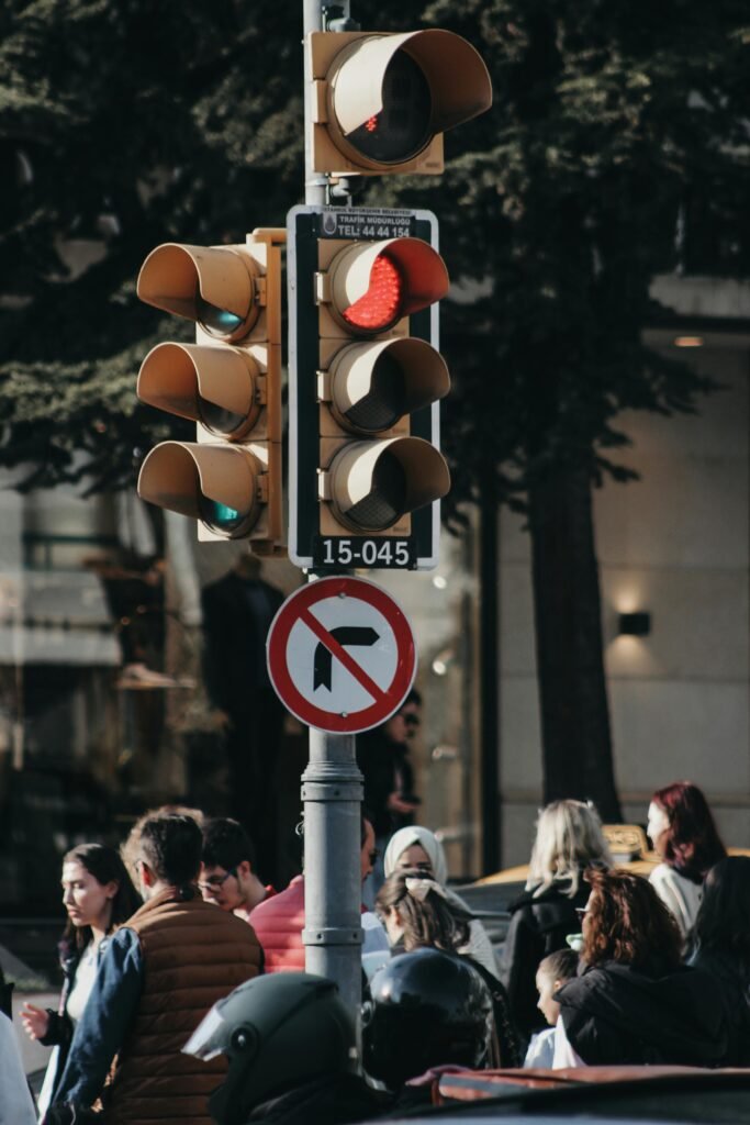 Urban street scene with group of pedestrians and traffic lights in downtown setting.