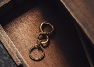 Close-up of an ornate brass infinity keychain on a wooden background, evoking a sense of elegance and mystery.